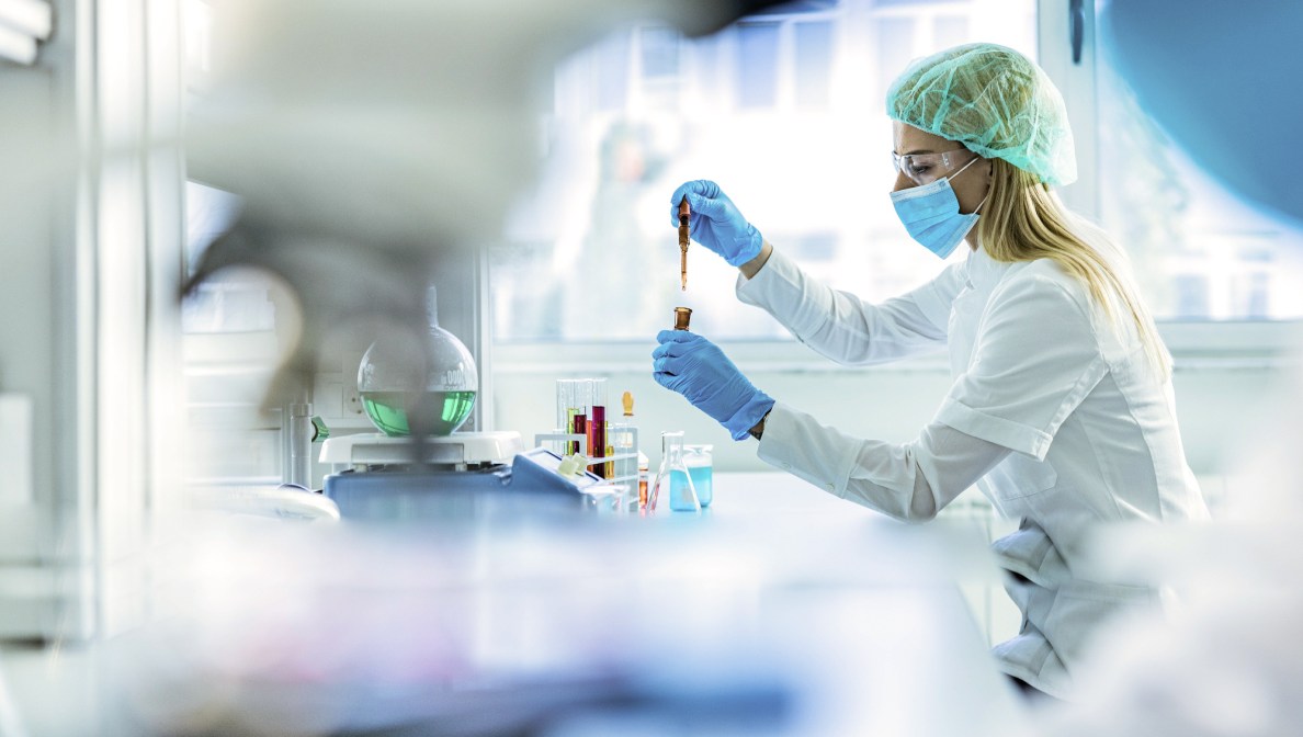Scientists working with test tubes in lab